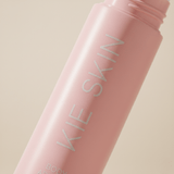 Close-up of the Kie Skin logo on the pink Body Adhesive roll-on bottle